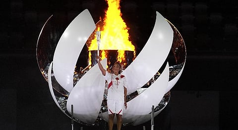 Japan's Naomi Osaka lights the cauldron during the opening ceremony in the Olympic Stadium at the 2020 Summer Olympics. (Photo | AP)