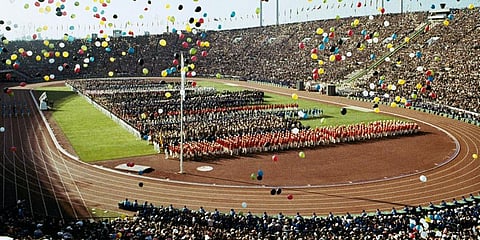 In this October 10, 1964, file photo, balloons fly over Olympians and spectators during the opening ceremony of the 1964 Summer Olympics at the National Stadium in Tokyo. (Photo | AP)