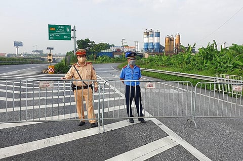 Policemen guard behind barricades set up to control the traffic in Hanoi (Photo | AP)