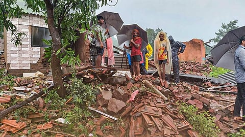 Locals at the site after several people died in a landslide at Taliye village in Satara district. (Photo | PTI)