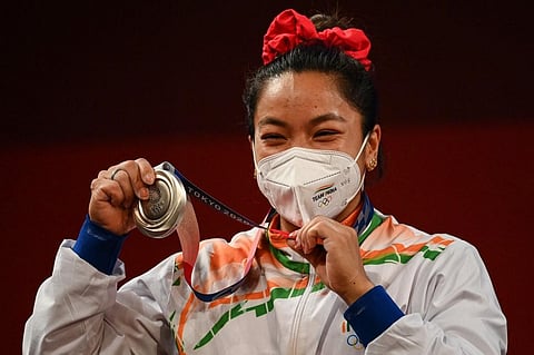 Silver medallist India's Chanu Saikhom Mirabai on the podium for victory ceremony of women's 49kg weightlifting competition during Tokyo Olympics 2020 on July 24, 2021. (Photo | AFP)