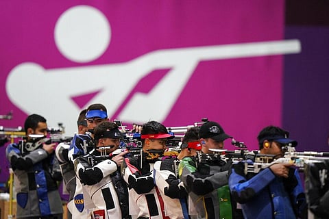 Athletes compete in the men's 10-meter air rifle at the Asaka Shooting Range in the 2020 Summer Olympics. (Photo | AP)