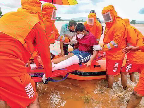 NDRF personnel evacuating an injured boy from a flood-affected village in Maharashtra’s Kolhapur on Sunday | PTI