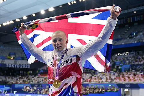 Adam Peaty of Britain celebrates after winning the final of the men's 100-meter breaststroke at the 2020 Summer Olympics. (Photo | AP)