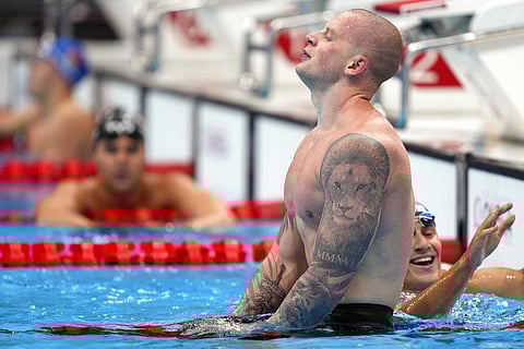 Adam Peaty of Britain rests after winning the final of the men's 100-meter breaststroke at the 2020 Summer Olympics. (Photo | AP)