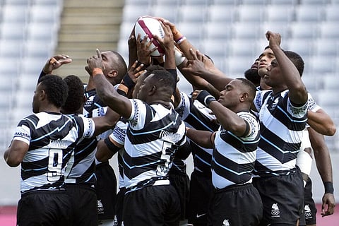 Members of Team Fiji hold the ball before the start of their men's rugby sevens match against Japan at the 2020 Summer Olympics. (Photo | AP)