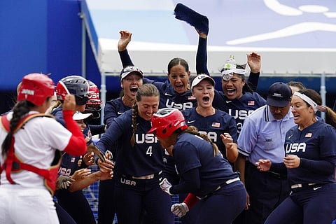 United States' Kelsey Stewart (7) is greeted at the plate by her teammates following her game winning home run against Japan in the seventh inning of a softball game. (Photo | AP)