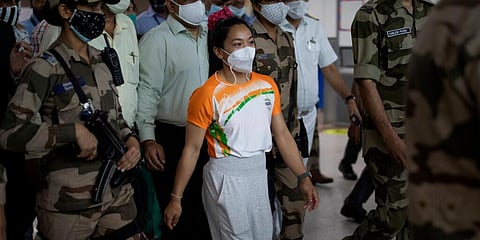 Indian weightlifter Mirabai Chanu who won the silver medal in Tokyo Olympics arrives at the airport in New Delhi, India. (Photo | AP)
