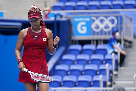 Naomi Osaka smiled as she spoke to reporters after a 7-5, 6-3 first-round loss to Angelique Kerber at the Paris Olympics.