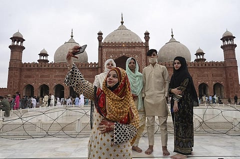 A woman takes a selfie with her friends after offering prayers at the historical Badshahi Mosque during the Eid al-Adha (Photo | AFP)