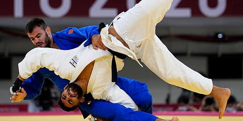 Arthur Margelidon of Canada and Tohar Butbul of Israel compete during their men's -73kg repechage contest judo match, at the 2020 Summer Olympics in Tokyo, Japan. (Photo | AP)