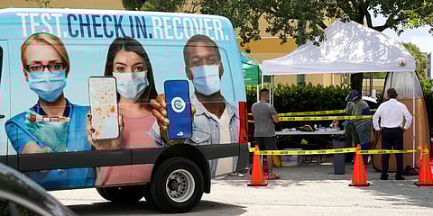 People wait in line at a Miami-Dade County COVID-19 testing site in Hialeah on Florida. (Photo| AP)