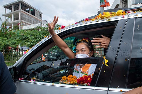 Olympic silver medallist Mirabai Chanu waves to the crowd after landing in Imphal. (Photo | Special Arrangement)