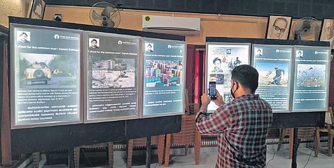 A spectator clicks one of the photographs taken by late Pulitzer-winning photojournalist Danish Siddiqui at an exhibition at Bharath Bhavan in Thiruvananthapuram | B P Deepu