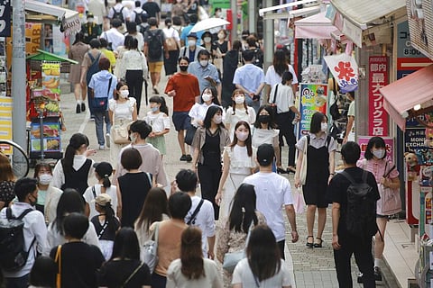 People wearing face masks to protect against the spread of the coronavirus walk through Takeshita street in Tokyo (Photo | AP)