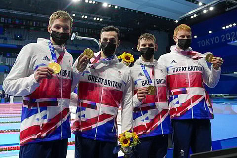 Britain's men's 4x200-meters relay team Tom Dean, James Guy, Matthew Richards, Duncan Scott posse after winning at the 2020 Summer Olympics. (Photo | AP)