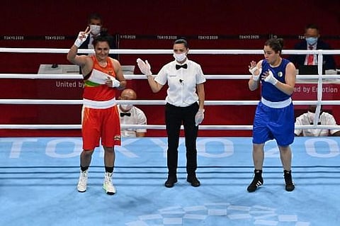 India's Pooja Rani Pooja Rani (red) celebrates after winning against Algeria's Ichrak Chaib fight after their women's middle (69-75kg) preliminaries round of 16 boxing match. (Photo | AFP)