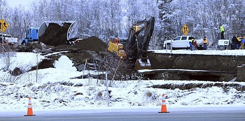 A dump truck and excavator work on a temporary fix of an off ramp that collapsed after an earthquake on Friday, Nov. 30, 2018, in Anchorage, Alaska. (File photo | AP)
