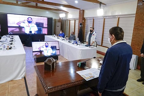 Philippine President Rodrigo Duterte, right, returns a salute from Olympic gold medalist weightlifter Hidilyn Diaz during a video conference. (Photo | AP)
