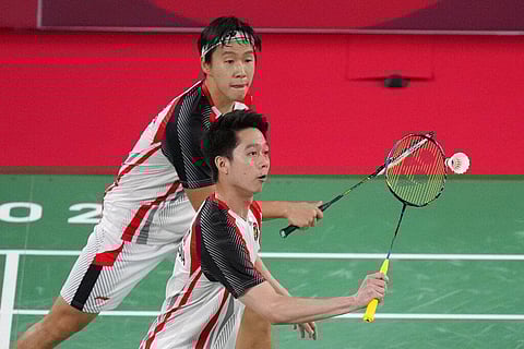 Indonesia's Marcus Fernaldi Gideon, top, and Kevin Sanjaya Sukamuljo play against Malaysia's Aaron Chia and Soh Wooi Yik during their men's doubles quarterfinal match. (Photo | AP)