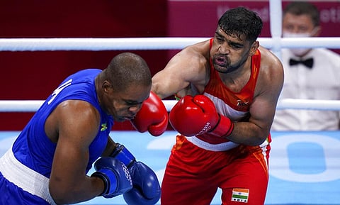 Satish Kumar, right, of India exchanges punches with Ricardo Brown of Jamaica during their men's super-heavy weight 91 kg preliminaries round Boxing match. (Photo | AP)