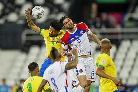 Brazil's Marquinhos, left, and Chile's Francisco Sierralta go for a header during a Copa America quarterfinal soccer match at the Nilton Santos stadium. (Photo | AP)