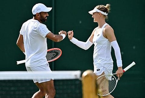 India's Divij Sharan (L) and Britain's Samantha Murray Sharan celebrate winning a point as they play against Uruguay's Ariel Behar and Kazakhstan's Galina Voskoboeva. (Photo | AFP)
