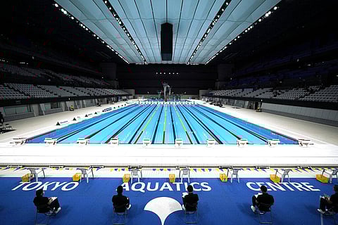 Tokyo 2020 Olympic Games Organizing staff prepare a Paralympic swimming test event at the Tokyo Aquatics Center. (Photo | AP)