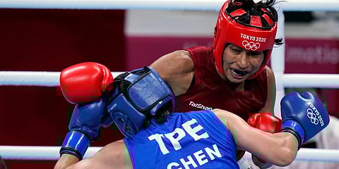 Lovlina Borgohain, of India, in red, delivers a punch to Nien-Chin Chen, of Chinese Taipei, during their women's welterweight 69kg quarterfinal match at the 2020 Olympics in Tokyo, Japan. (Photo | AP)
