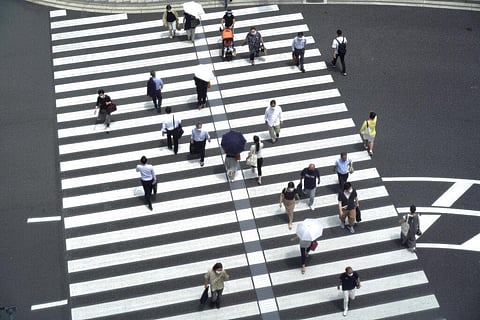 People walk across a crossing near Tokyo Station in Tokyo Thursday, July 29, 2021, a day after the record-high coronavirus cases were found in the Olympics host city. (Photo | AP)