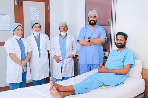 Dr Tinku along with his team with the patient Sooraj at Amrita Hospitals. (Photo | EPS)