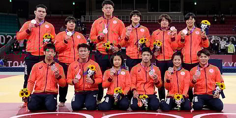 Members of Japan's team pose with their silver medals after the medal ceremony in team judo competition at the 2020 Summer Olympics in Tokyo, Japan. (Photo | AP)