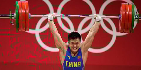 Lyu Xiaojun of China competes in the men's 81kg weightlifting event, at the 2020 Summer Olympics in Tokyo, Japan. (Photo | AP)