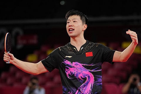 Ma Long of China makes a gesture after defeating Fan Zhendong of China during the gold medal match of the table tennis men's singles at the 2020 Summer Olympics. (Photo | AP)