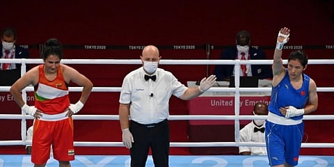 China's Li Qian celebrates after winning against India's Pooja Rani Pooja Rani after their women's middle (69-75kg) quarter-final boxing match during the Tokyo 2020 Olympic Games. (Photo | AFP)