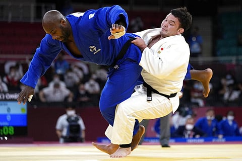 Teddy Riner of France, left, and Aaron Wolf of Japan compete during their gold medal match in team judo competition. (Photo | AP)