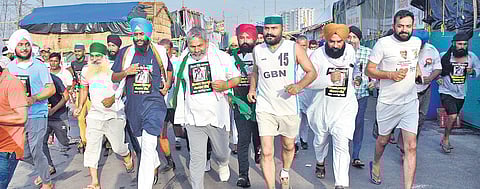BKU leader Rakesh Tikait (C) participates in Kisan Mazdoor Marathon at Ghazipur border in memory of Milkha Singh | PTI