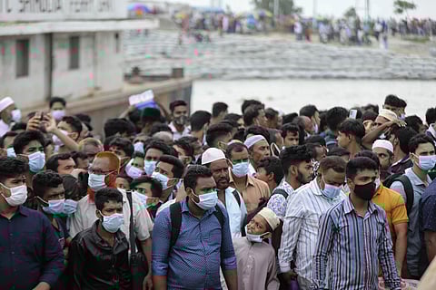 People crowd a ferry terminal to leave the city ahead of a lockdown set to start on July 1, at the Shimulia ferry terminal in Munshiganj, on the outskirts of Dhaka. (Photo | AP)