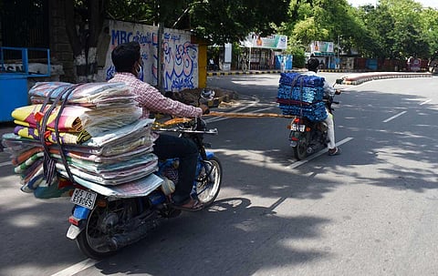 To save fuel, a trader tows a bike by tying a piece of cloth to it at Lakdi-ka-pul in Hyderabad. (Photo | S Senbagapandiyan, EPS)