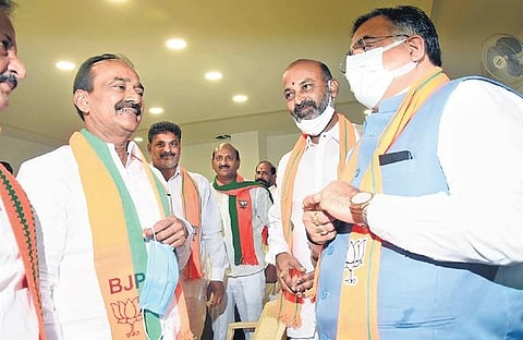 BJP’s Telangana in-charge Tarun Chugh and party’s State president Bandi Sanjay speak to former minister Eatala Rajender before the start of Huzurabad byelection.