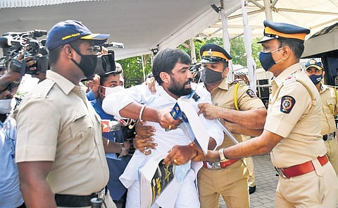 BJP legislator Ram Satpute is taken away by policemen during the stormy opening day of Maharashtra Assembly, in Mumbai. (Photo | PTI)