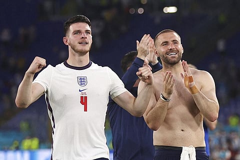 England's Declan Rice, left, and England's Luke Shaw applaud fans at the end of the Euro 2020 soccer championship quarterfinal soccer match between Ukraine and England. (Photo | AP)