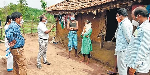 Mulugu DMHO Dr Allam Appaiah and team hand over required medicines and mosquito nets to a tribals in an Agency area. (Photo | EPS)