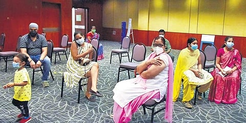 People wait in the observation area after taking a Covid vaccine at a special vaccination drive at HICC in Hyderabad. (Photo | EPS)