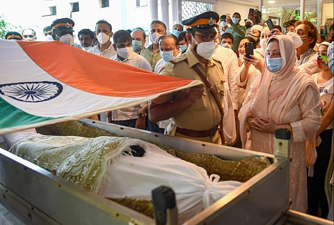Police personnel wrap tricolor during the guard of honour to Bollywood legendary actor Dilip Kumar on his funeral, in Mumbai, Wednesday, July 7, 2021. (Photo | PTI)
