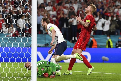 Denmark's Simon Kjaer, right, watches as England's Harry Kane, center, runs to celebrate after scoring his sides second goal past Denmark's goalkeeper Kasper Schmeichel. (Photo | AP)