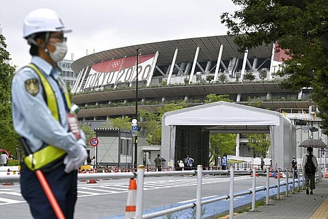 A security guard wearing face masks guards outside the National Stadium in Tokyo, Thursday, July 8, 2021. (Photo | AP)