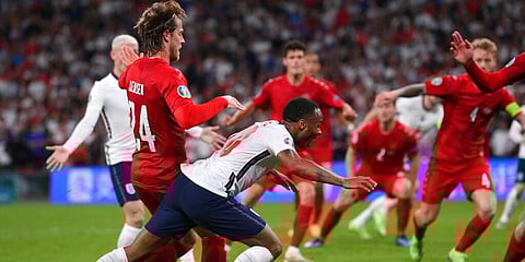 England's Raheem Sterling is fouled by Denmark's Mathias Jensen and a penalty is awarded during the Euro 2020 semifinal game. (Photo | AP)
