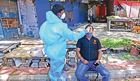 A health worker collects a nasal swab sample from a food delivery agent, as part of the Covid testing drive, in Bengaluru| Ashishkrishna HP