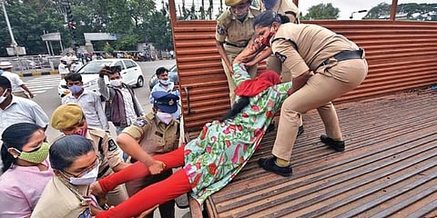 Police detain a BJP Mahila Morcha activist who staged a protest in support of outsourced nurses, in Hyderabad. (Photo | RVK Rao, Express)